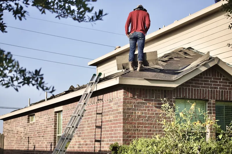 Professional roofer working on a residential roof in North Pepperell